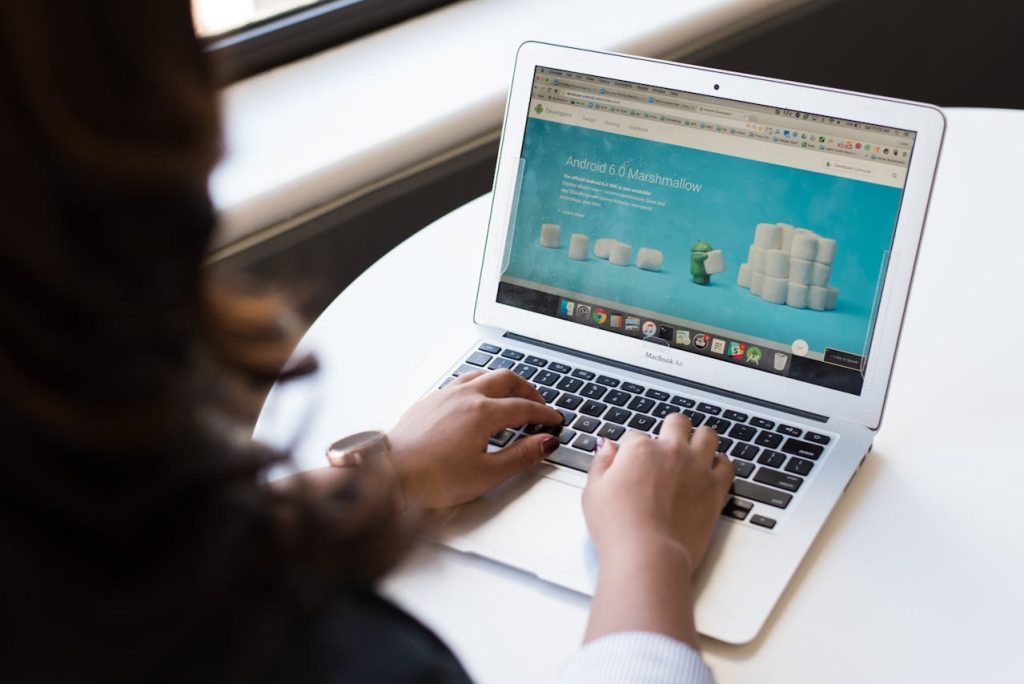 a woman looking at android 6.0 on a laptop